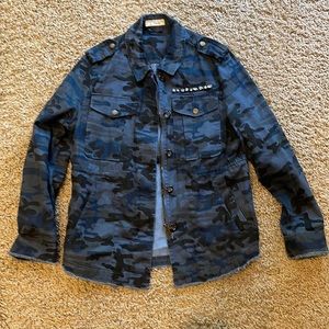 Camo jean jacket with embellishments.